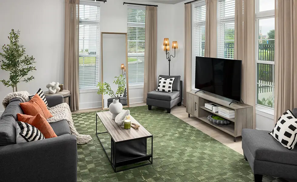 Living area with an armchair, table, and TV